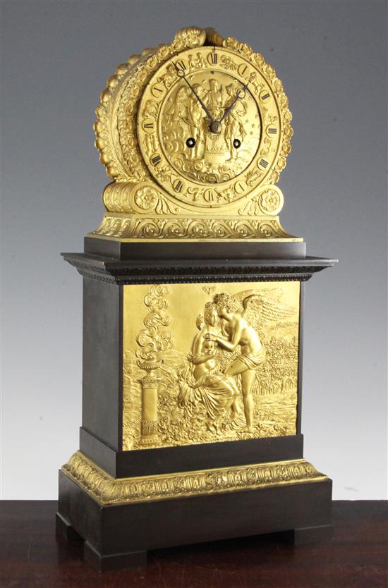 A 19th century French bronze and ormolu Empire style mantel clock, 18.75in.